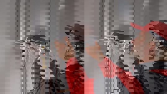 Plumber installing tankless water heater